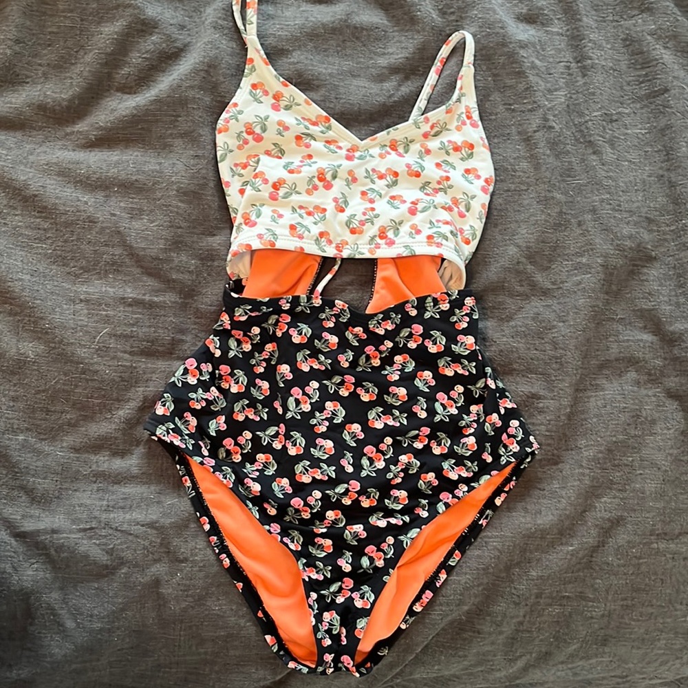 one piece bathing suit with cut out in center.